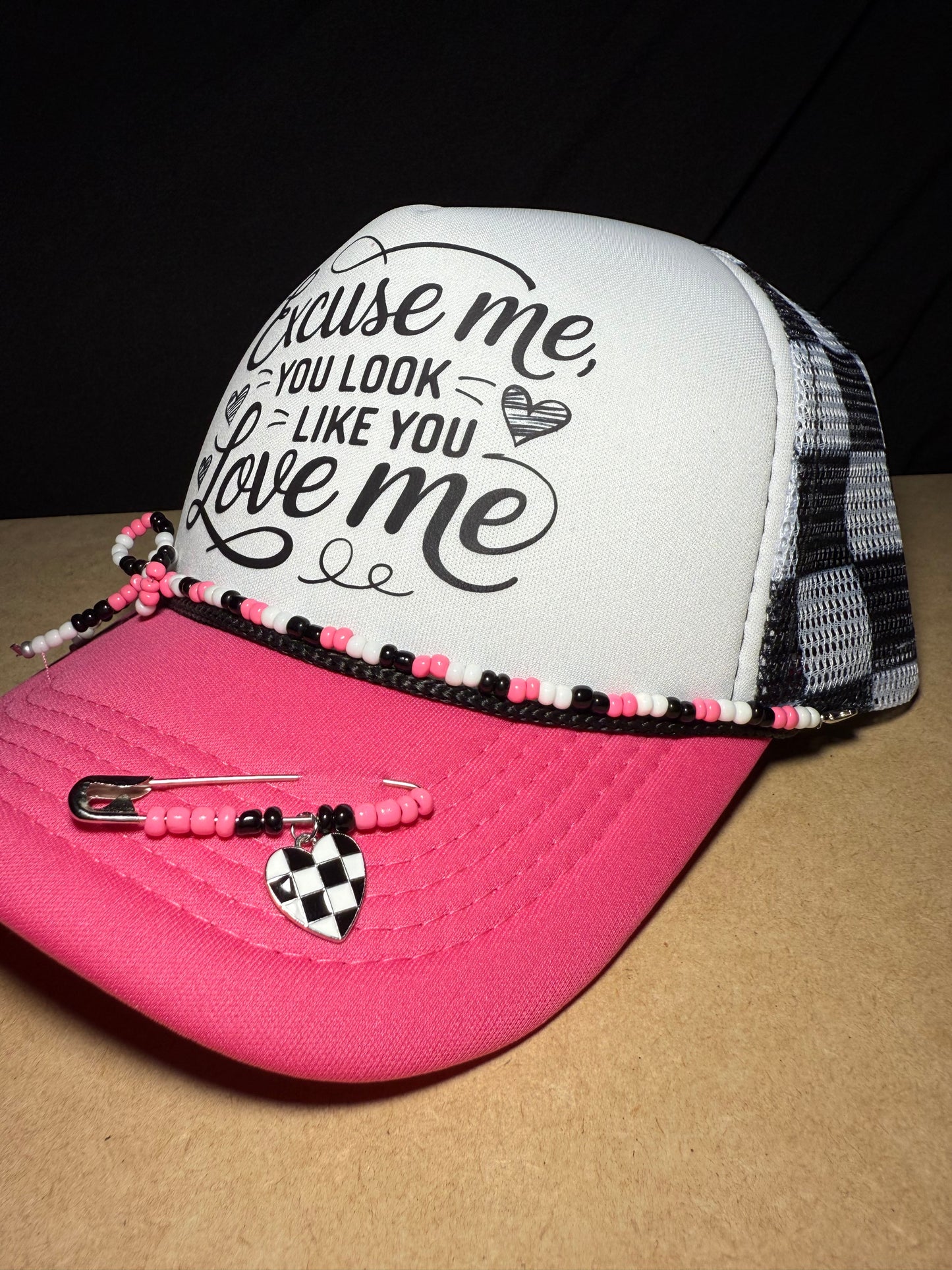 Excuse me, you look like you love me. Checkered adjustable back with white foam front. Adorable!