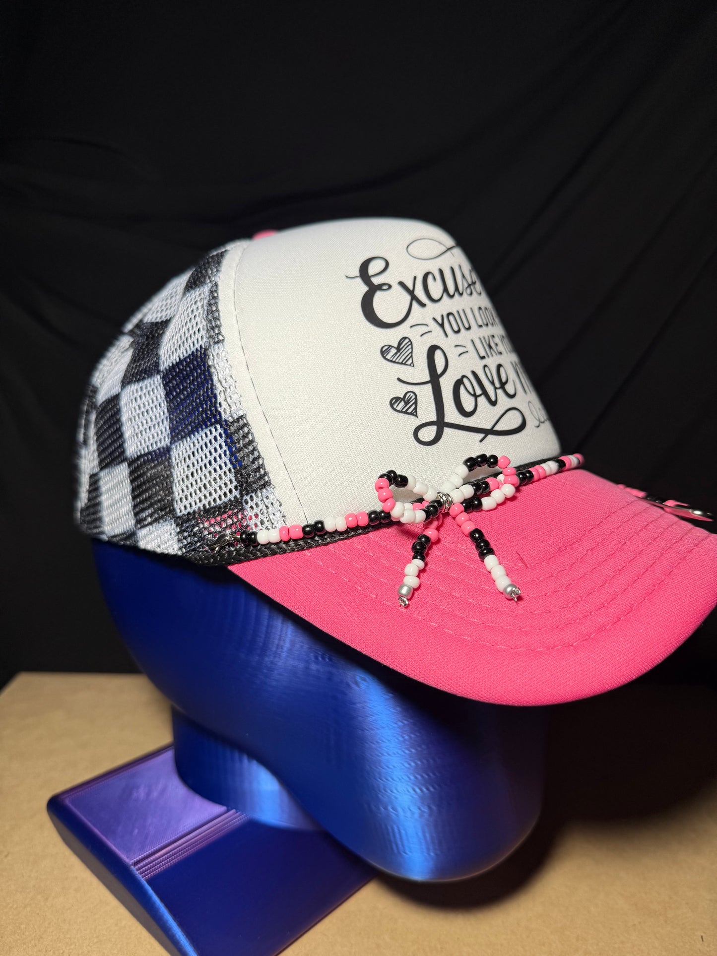 Excuse me, you look like you love me. Checkered adjustable back with white foam front. Adorable!